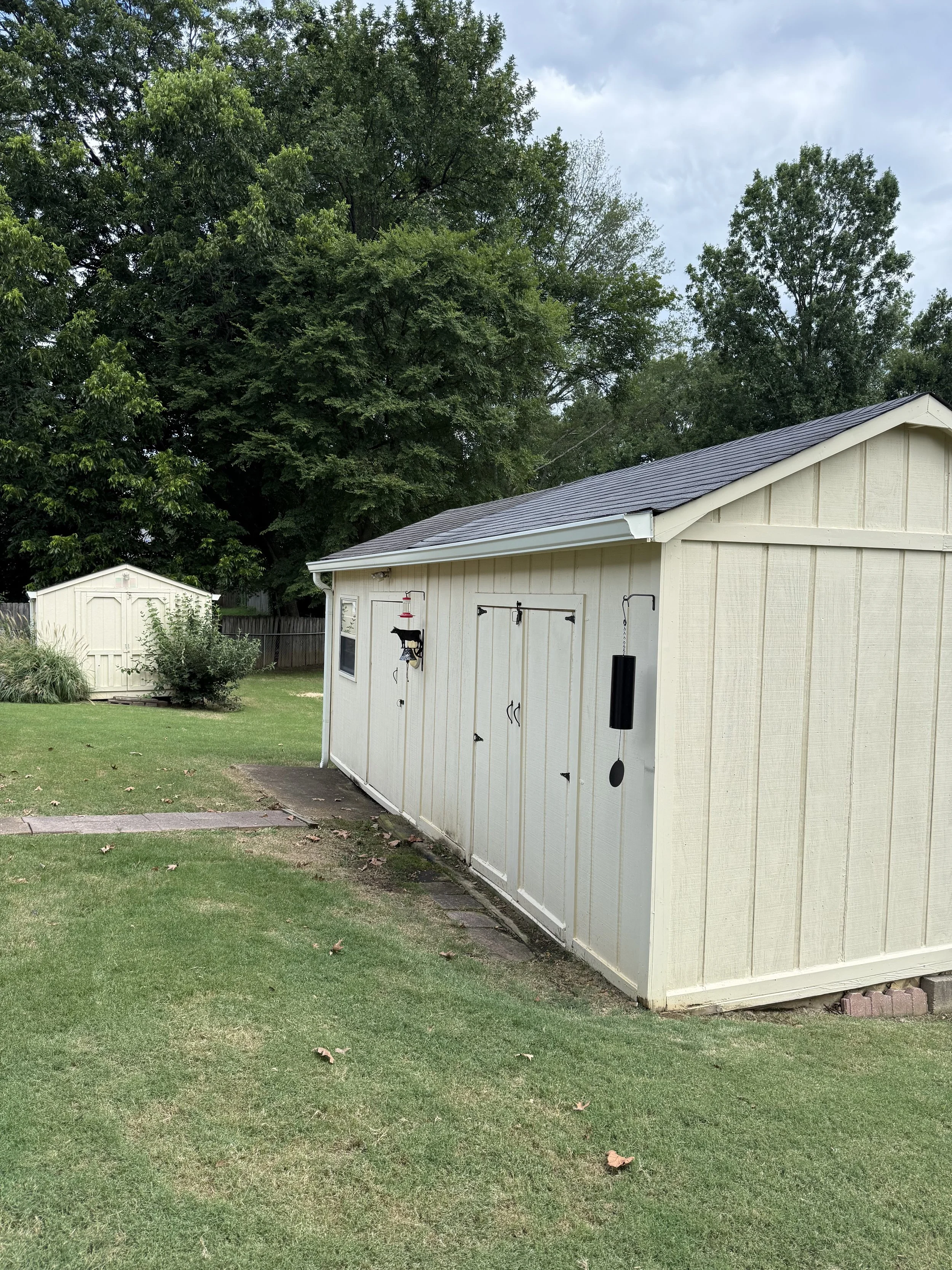 Custom white seamless gutters professionally installed to help protect the workshop from water runoff and foundation erosion.