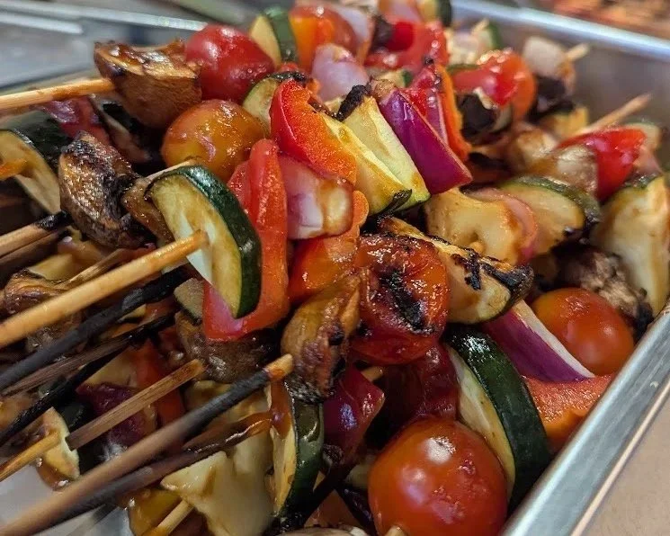 Succulent vegetable skewers filled with grilled vegetables including cherry tomatoes, zucchini, red bell peppers, halloumi and onions.