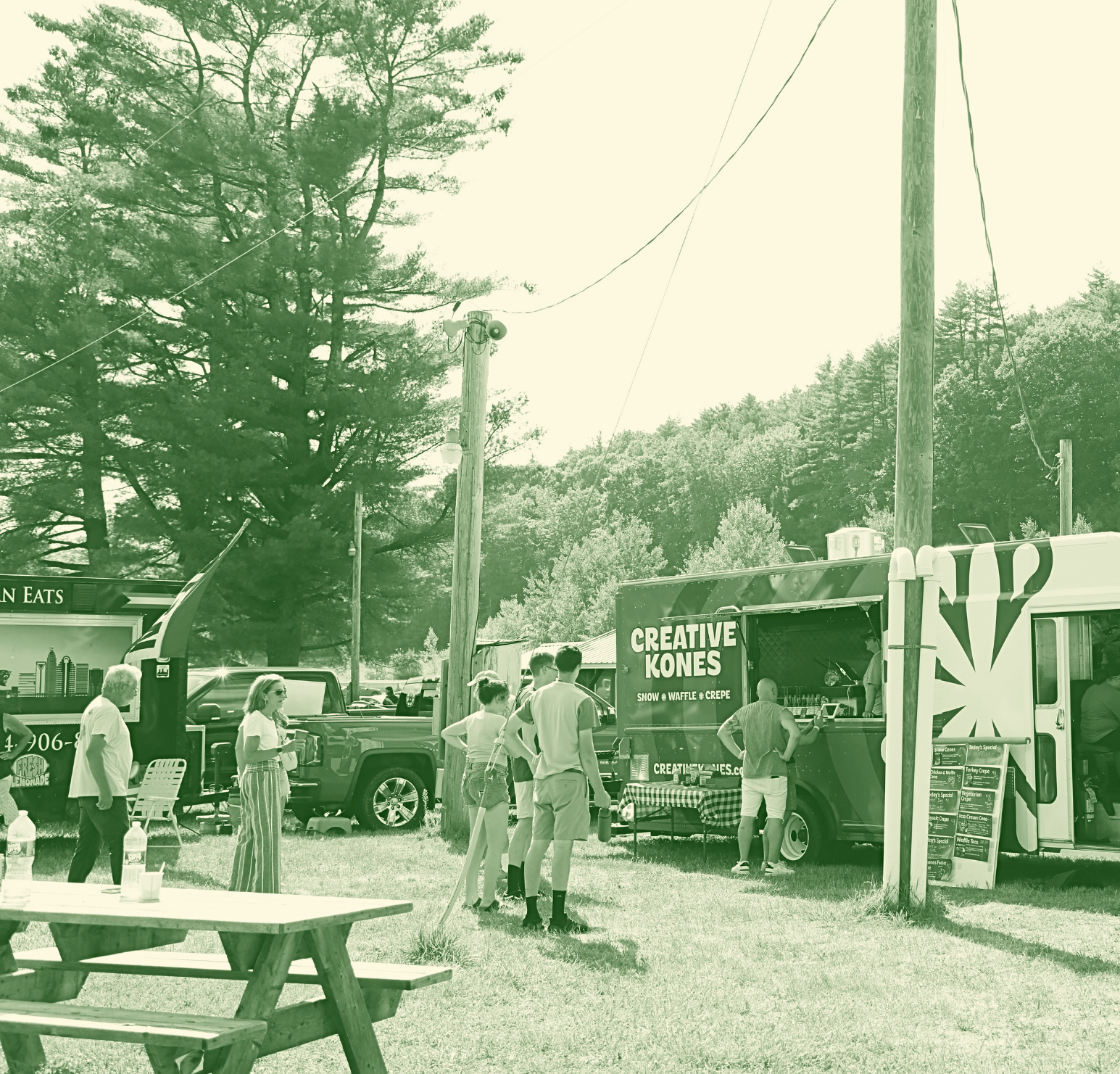 A food truck named 'Creative Kones' serving snow, waffle, and crepe, with people waiting in line outdoors among trees and utility poles.