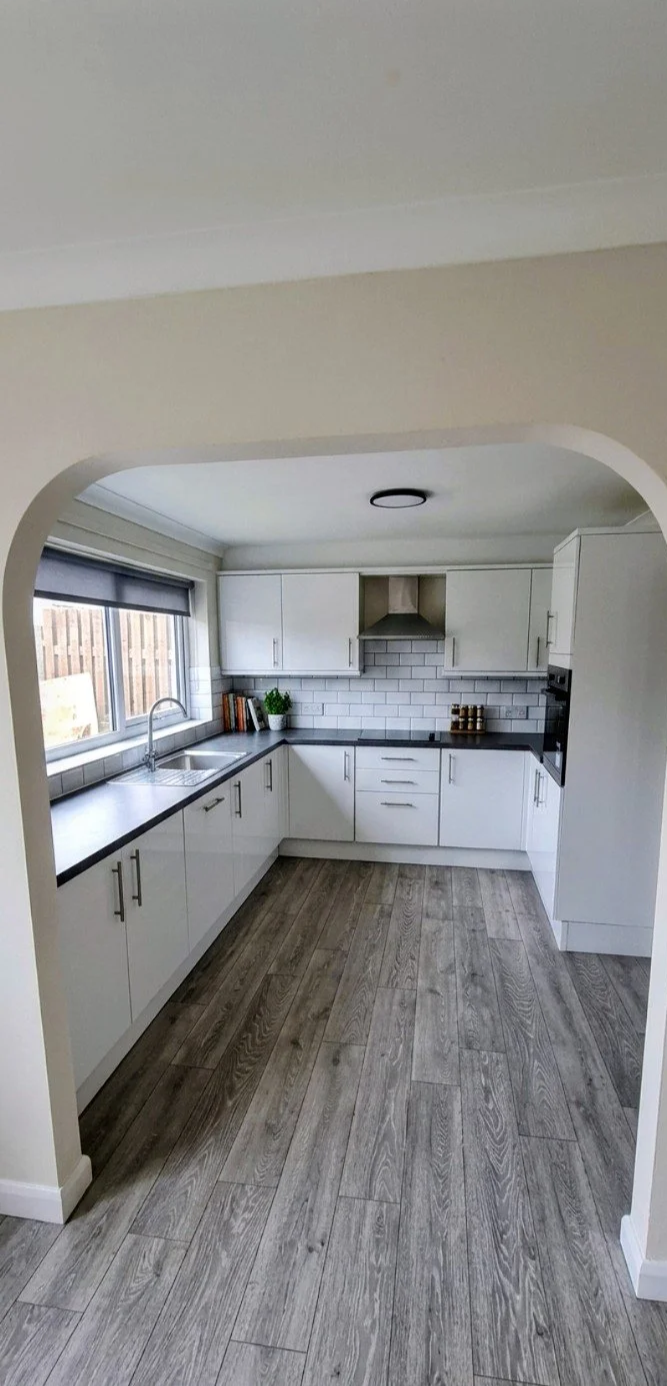 Modern Kitchen Fit: High-gloss handleless units. Subway tile backsplash. Premium wide-plank flooring. Full strip-out and installation.