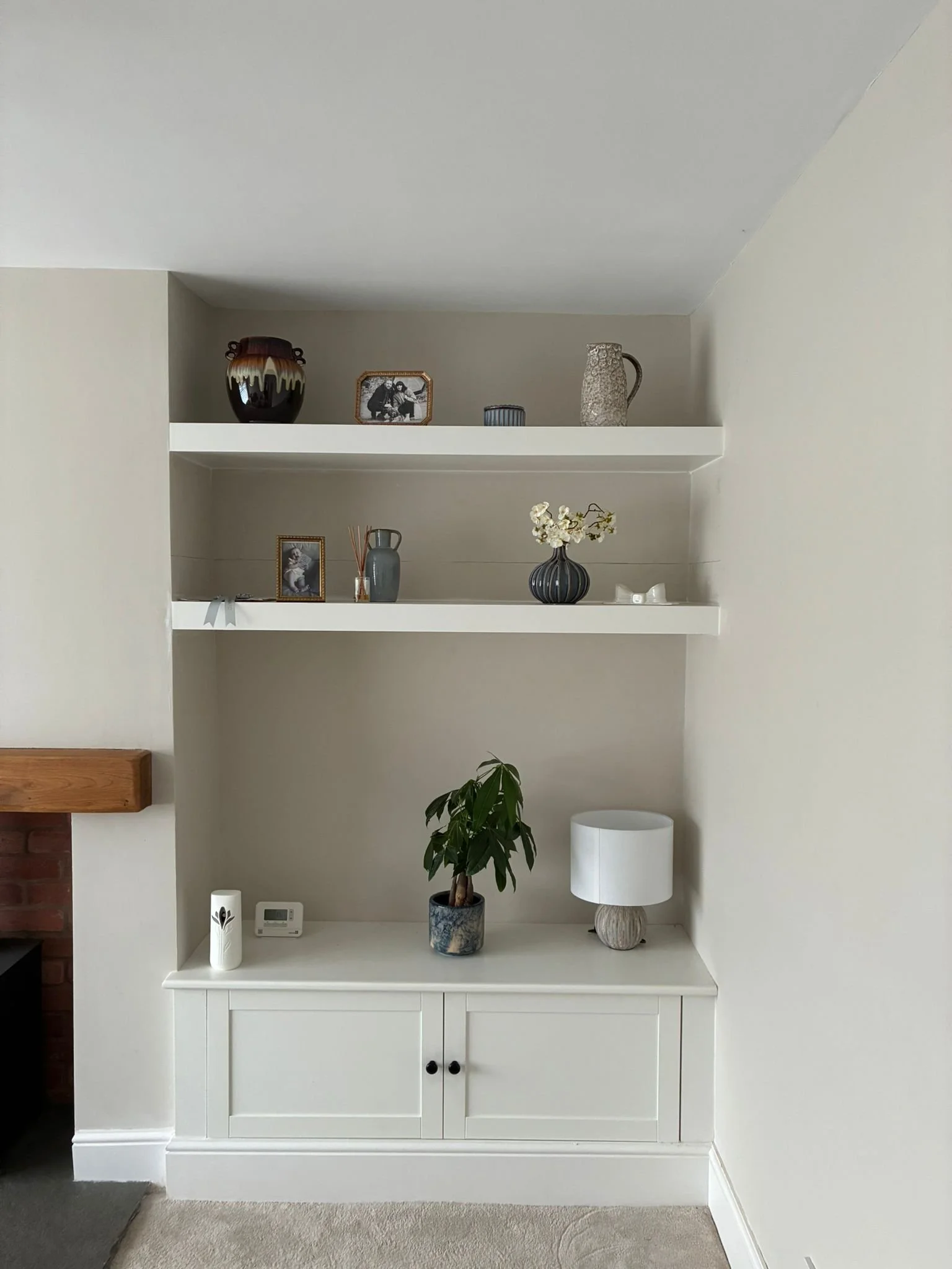 Bespoke Alcove Unit: Shaker-style base cabinet. Integrated skirting. Custom floating shelves. Hand-finished in satin white.
