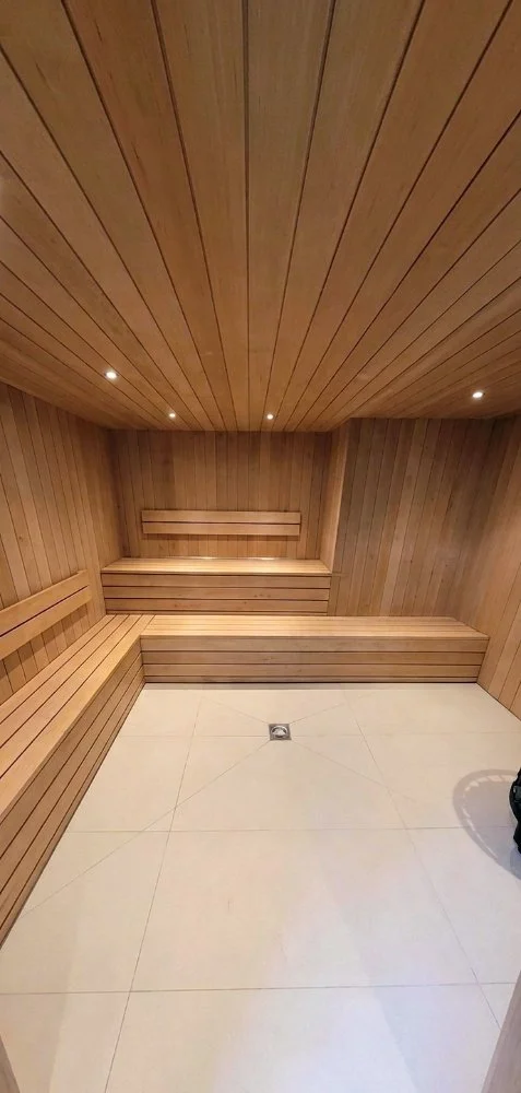 Bespoke Home Sauna: Precision timber cladding. Integrated LED lighting. Hand-crafted floating benches. Luxury spa-quality finish.