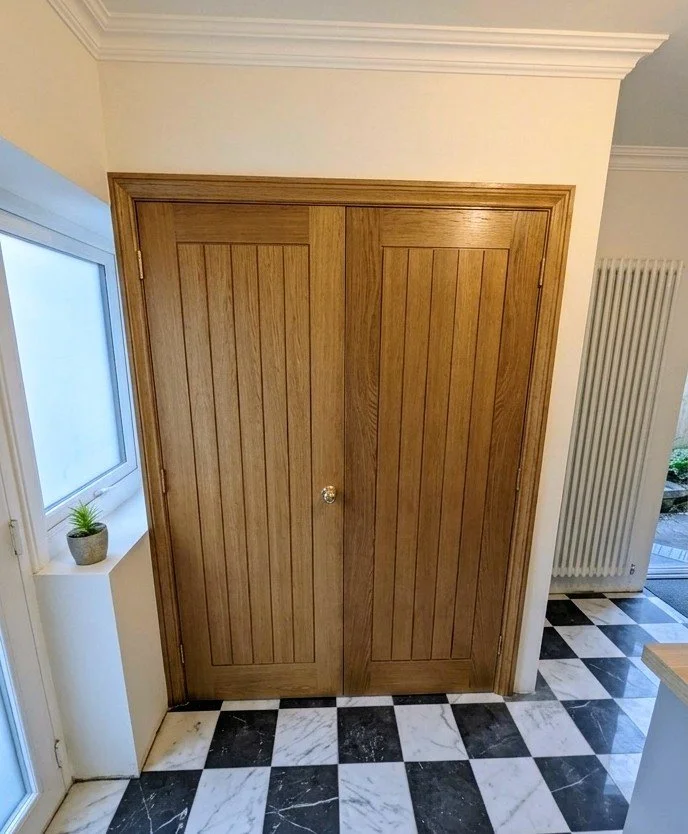 Custom Oak Double Doors: Hand-finished European Oak. Vertical panel design. Precision architrave fitting to match existing period features.