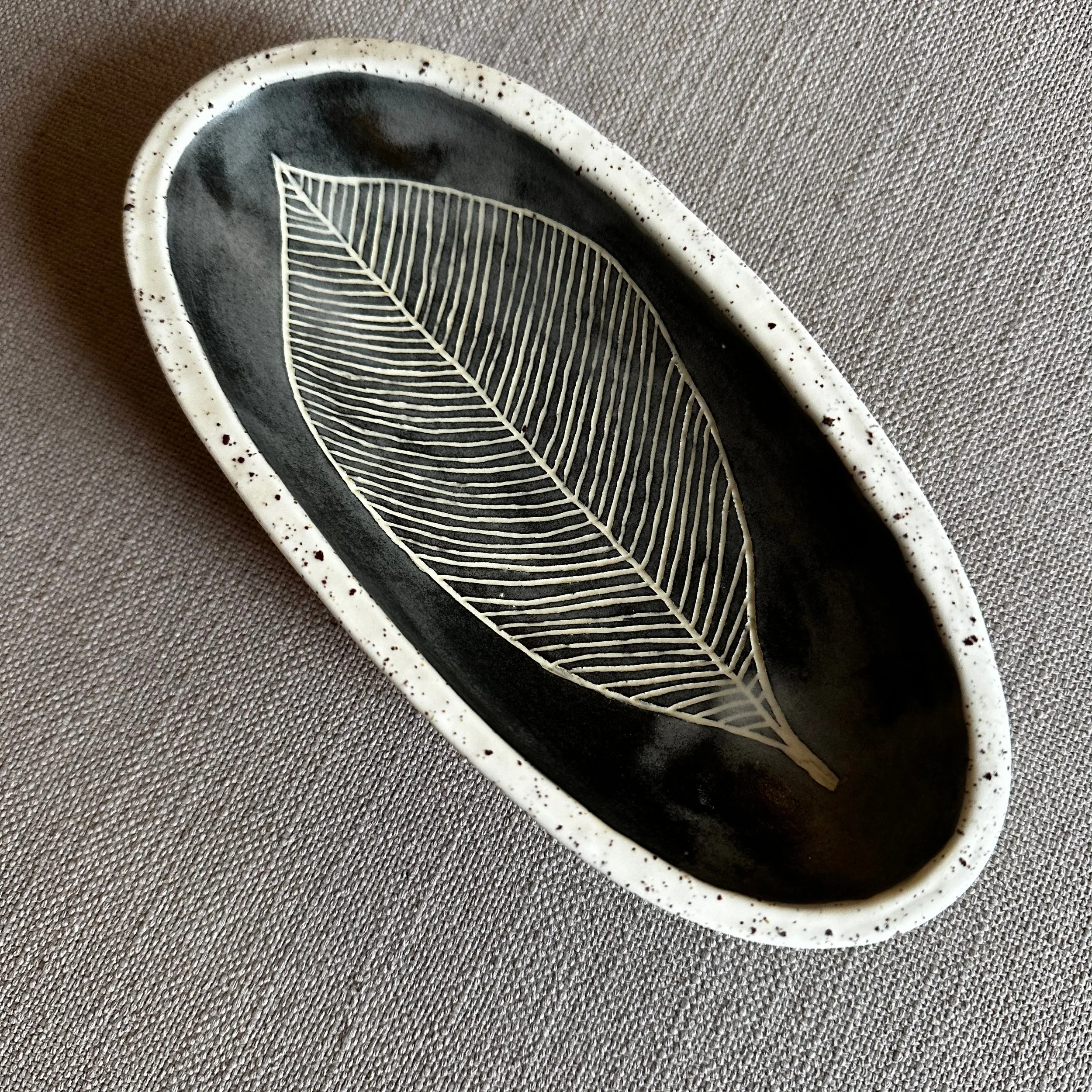 ceramic bowl with hand-carved leaf illustration