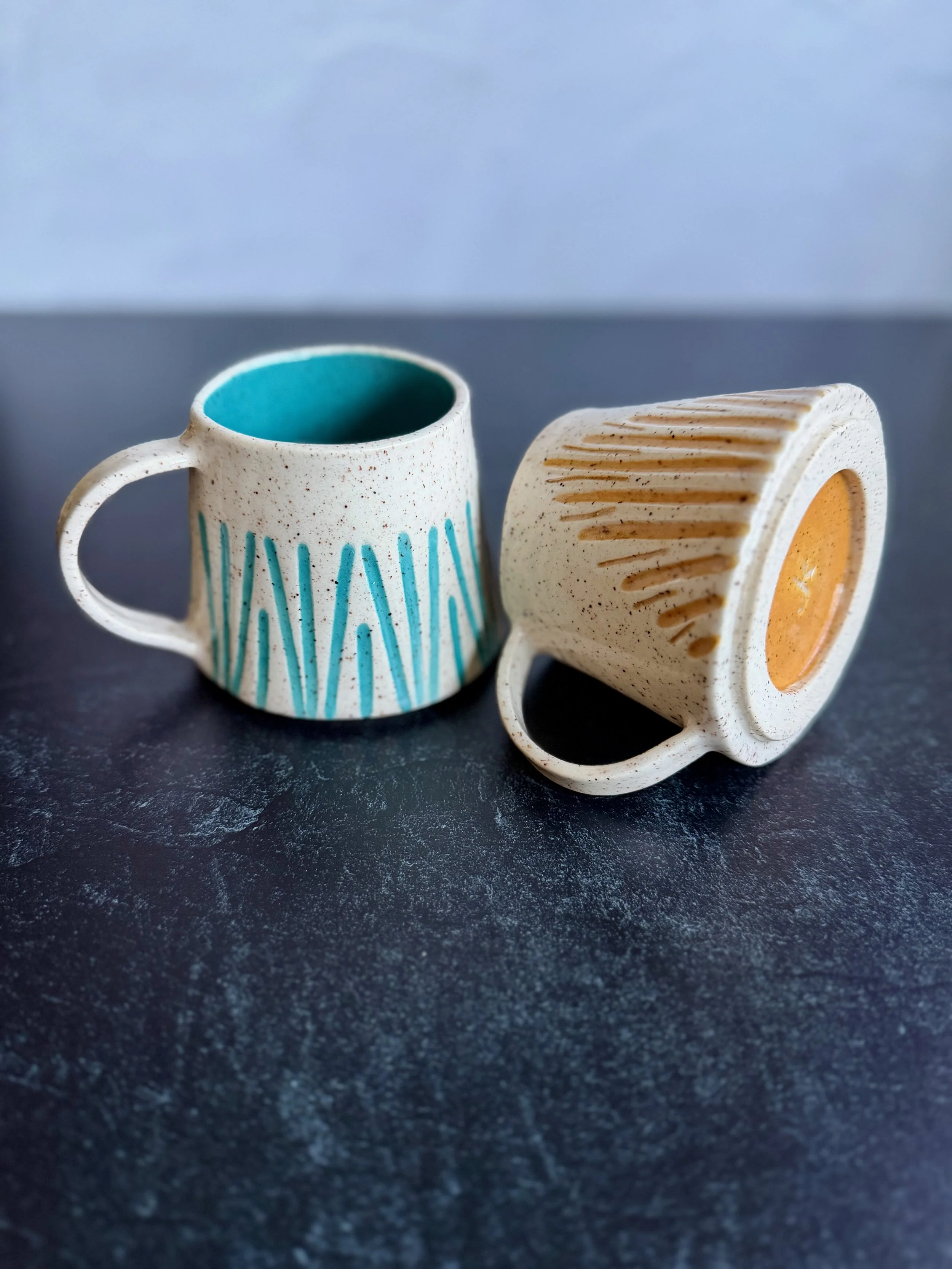 Hand built and carved ceramic mugs