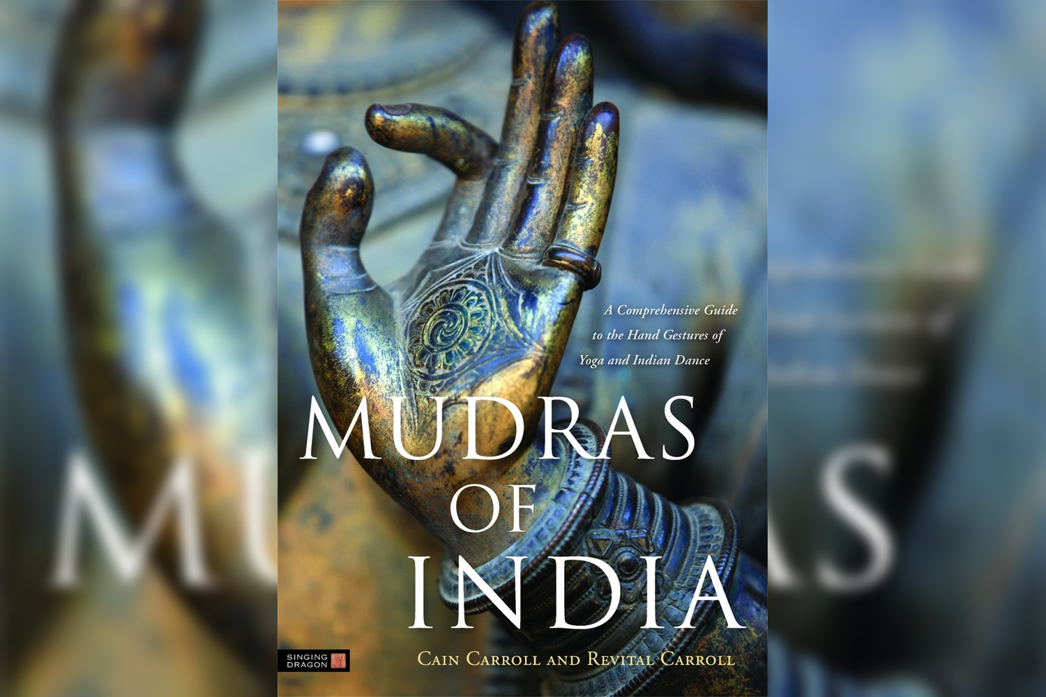 Book cover titled 'Mudras of India' featuring a close-up photograph of a decorated hand making a gesture. The hand has intricate henna-like patterns and jewelry, with a blurred background.