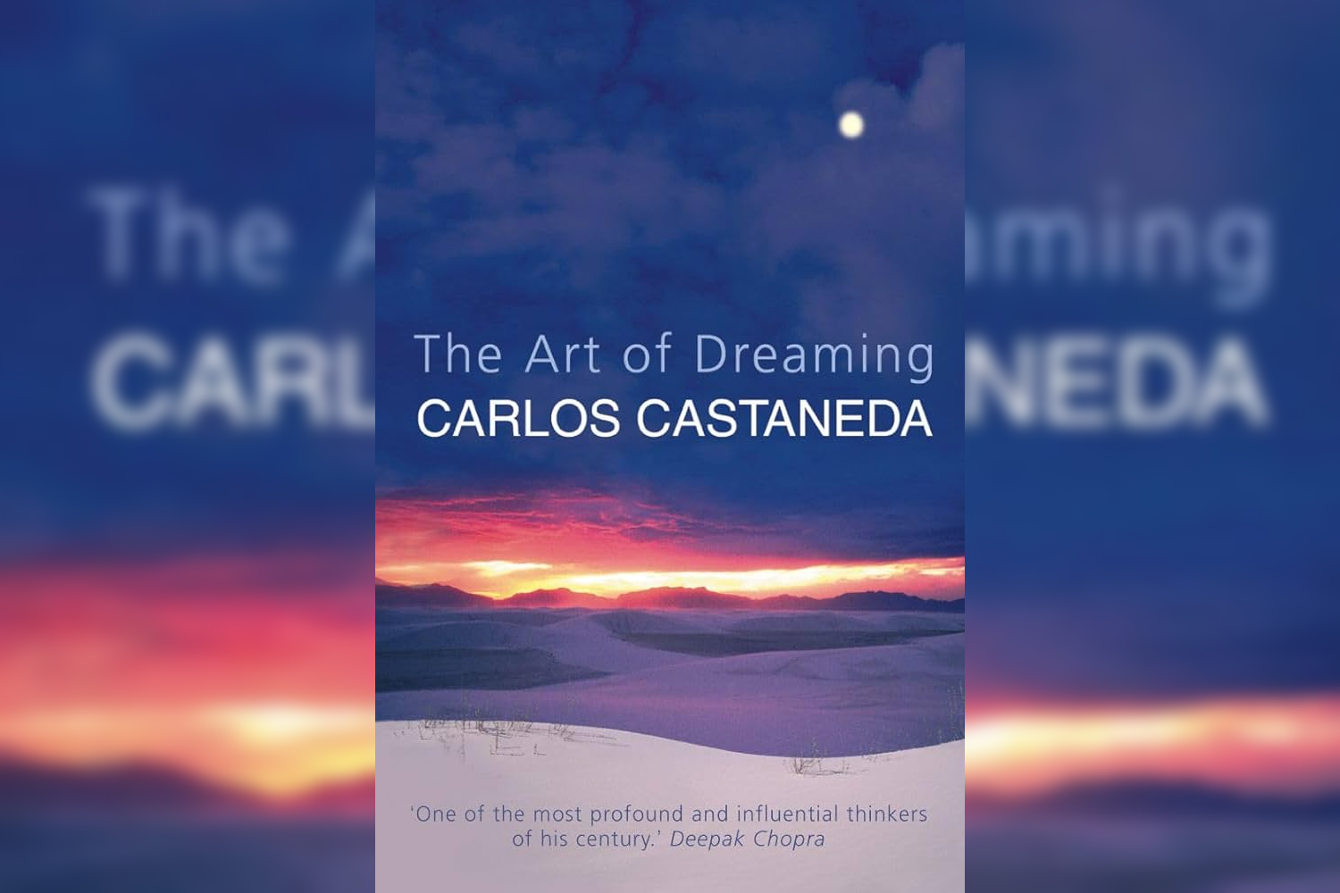 Book cover of 'The Art of Dreaming' by Carlos Castaneda, featuring a landscape with rolling hills at sunset, a dark blue sky with a moon, and a quote from Deepak Chopra.
