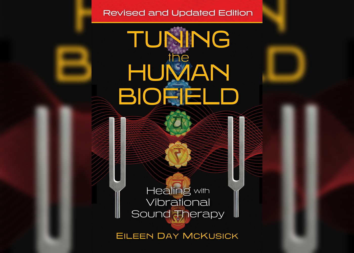 Book cover titled 'Tuning the Human Biofield' with subtitle 'Healing with Vibrational Sound Therapy' by Eileen Day McKusick. The cover features a black background with colorful chakra symbols, red wave patterns, and two tuning forks on either side.