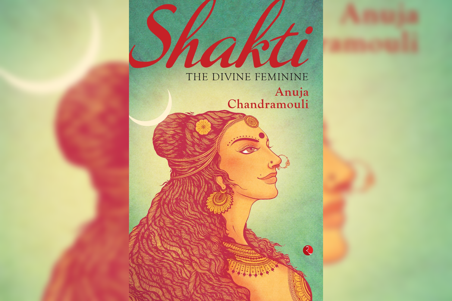 Book cover titled "Shakti: The Divine Feminine" by Anuja Chandramouli. The cover features an illustration of a woman with elaborate jewelry, long textured hair, and traditional attire, against a green background with a crescent moon and sun in the to