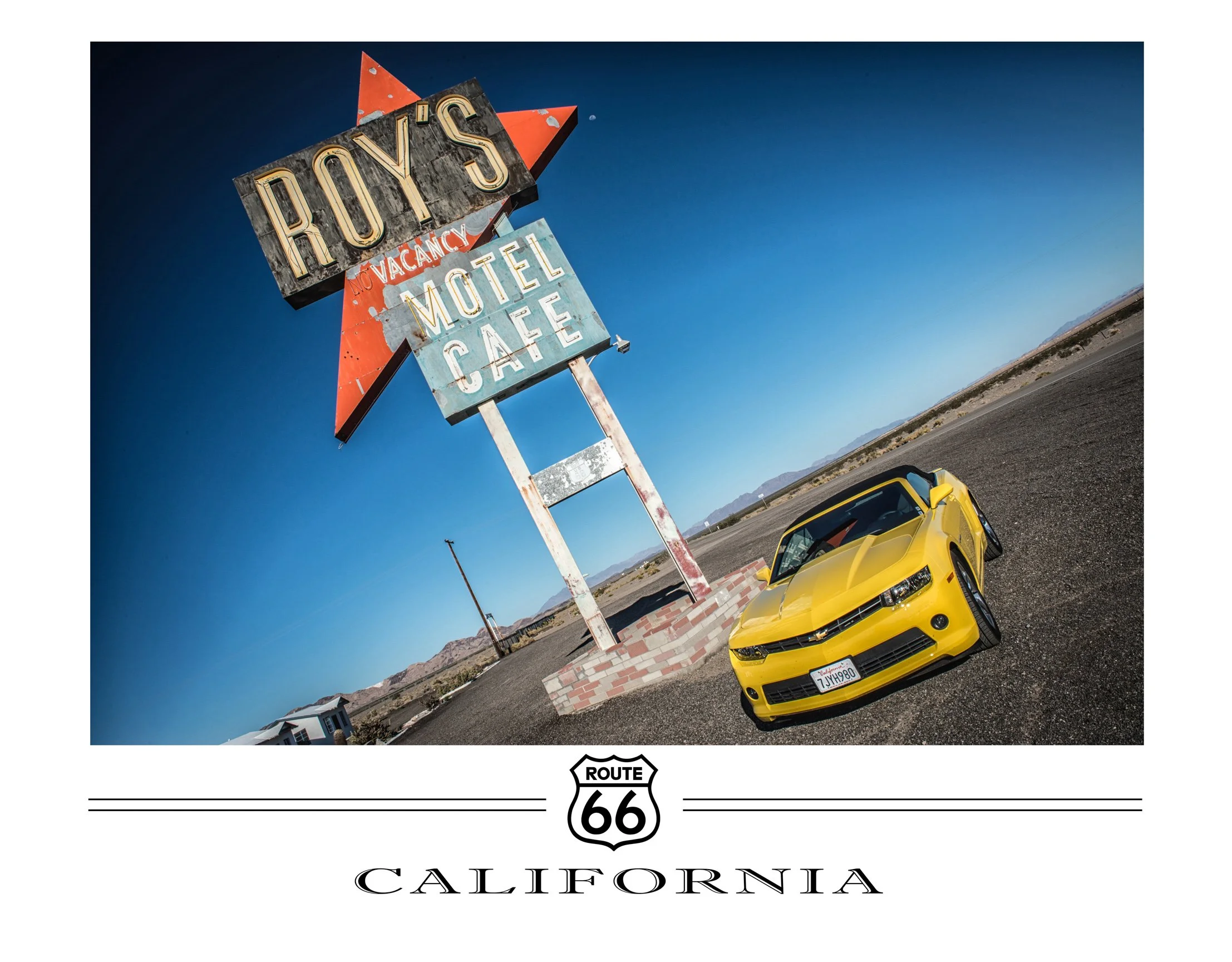 A yellow sports car parked in front of a vintage motel and cafe sign on Route 66 in California, with clear blue skies and distant mountains.