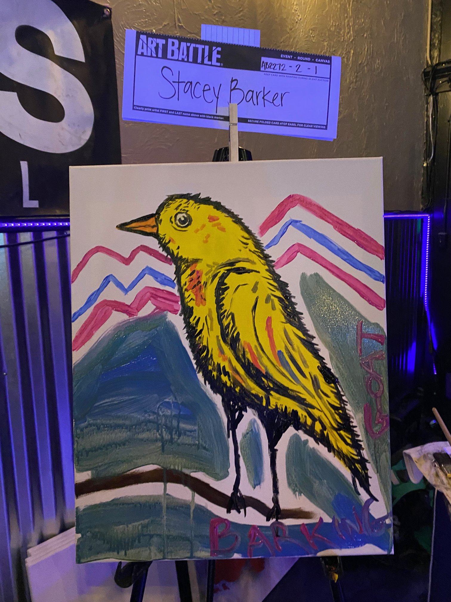 A colorful art piece of a yellow bird with black and orange details, standing on a branch amidst a mountain landscape. The background features stylized pink and blue mountain peaks and a dark mountain with a snowy top. Handwritten text and bold lette