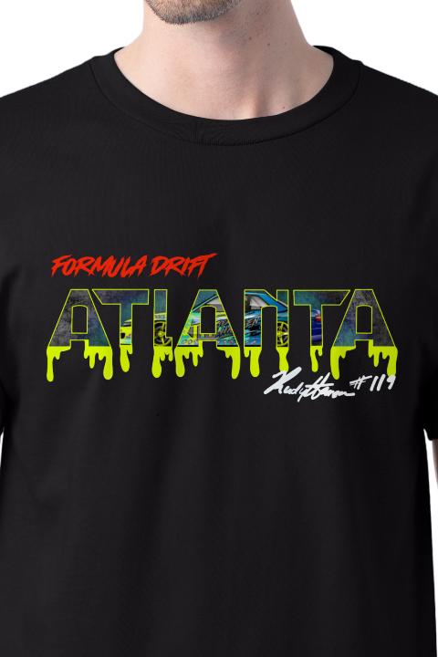 Close-up of a person wearing a black T-shirt with yellow-green dripping text that says "ATLANTA" and smaller texts in red and white, including "Formula Drift" and "K-Style Inc."