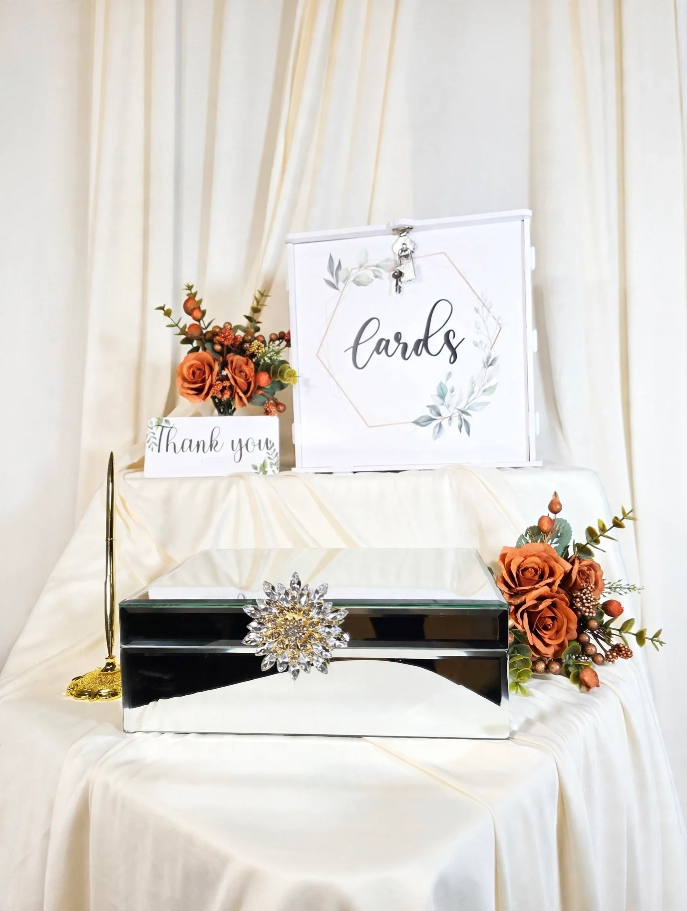 White card box and mirrored box with orange roses, thank you sign, and gold pen