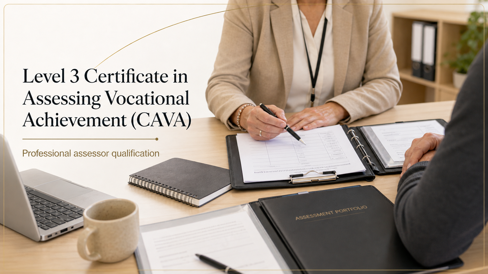 A professional assessor and a person sitting at a desk during a certification interview for a Level 3 Certificate in Assessing Vocational Achievement (CAVA). The assessor is holding a pen and reviewing documents, with a laptop, notebooks, assessment portfolio folder, and a coffee mug on the desk.