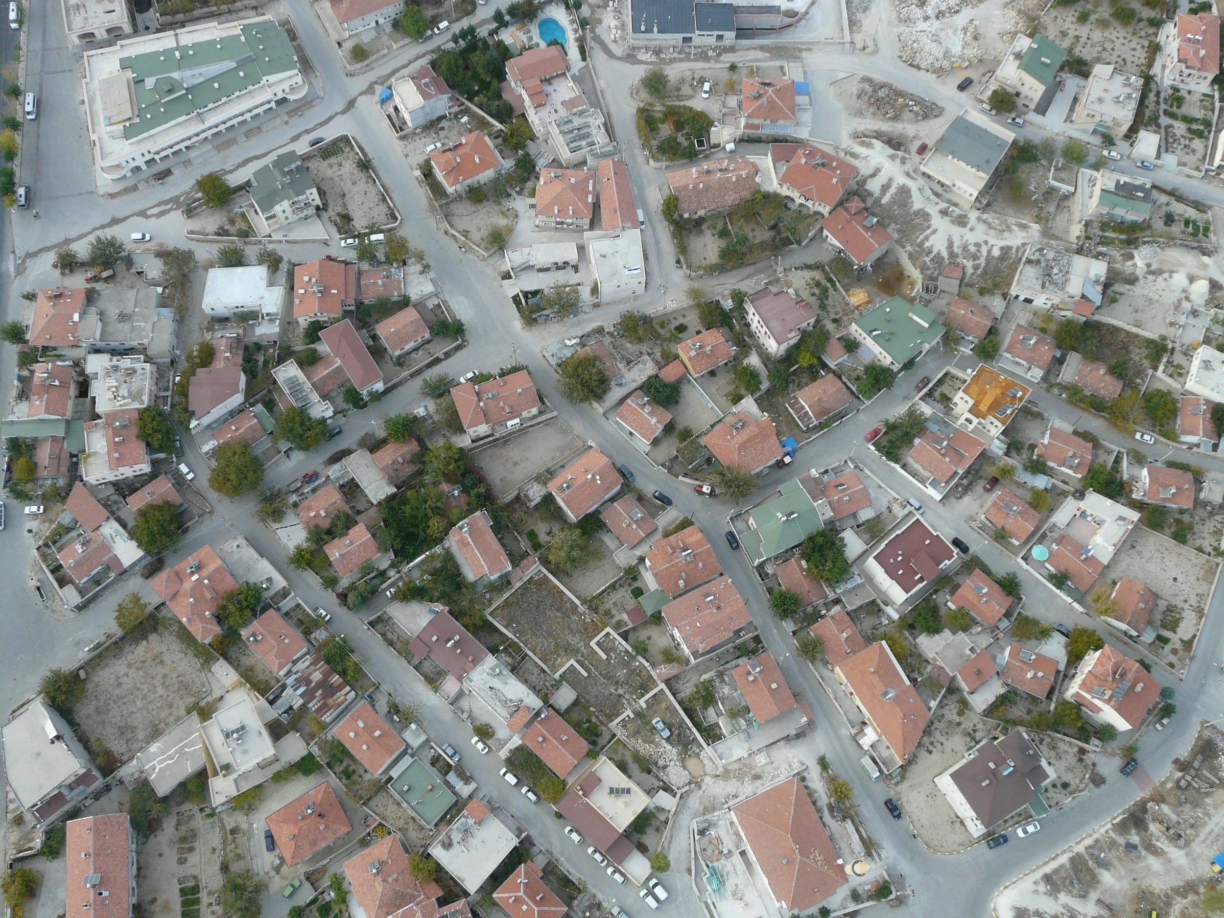 An aerial view of a residential neighborhood with houses, trees, and streets.