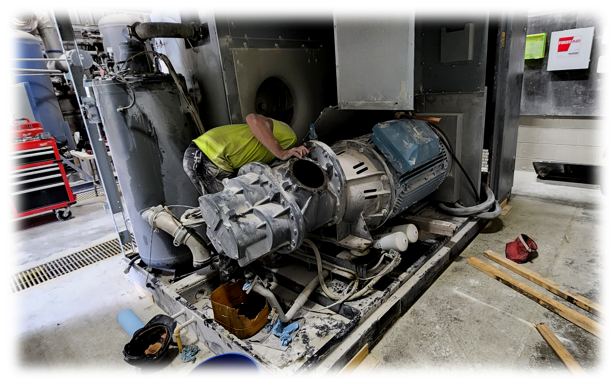 Technician performing mechanical repairs and diagnostics on industrial processing equipment.