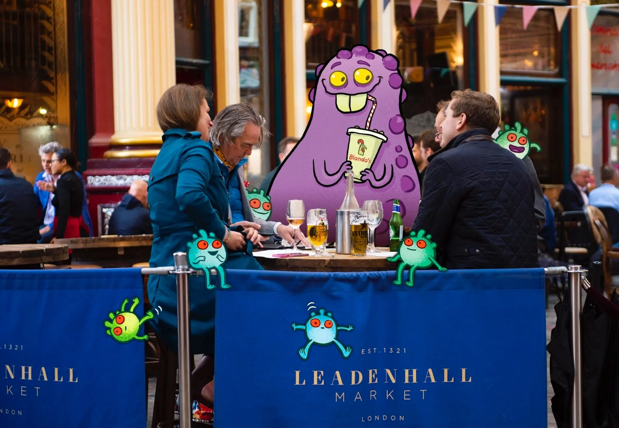 People sitting at a table outside Leadenhall Market in London, engaging in conversation with animated cartoon virus characters adding a playful element to the scene.
