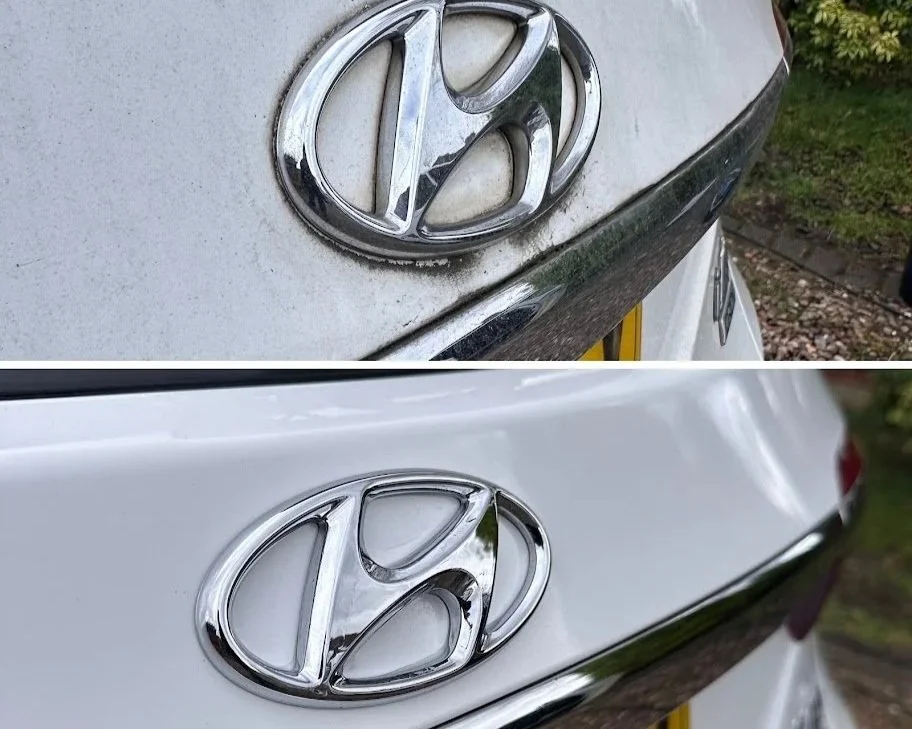 Comparison of a dirty and a cleaned Hyundai logo on a car's rear.