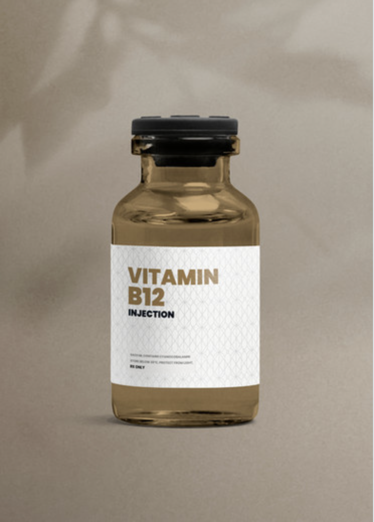 A small glass vial labeled 'Vitamin B12 Injection' with a black cap, placed on a neutral surface against a plain background. Defy RS | Daxxify & Lip Filler in Pueblo West CO