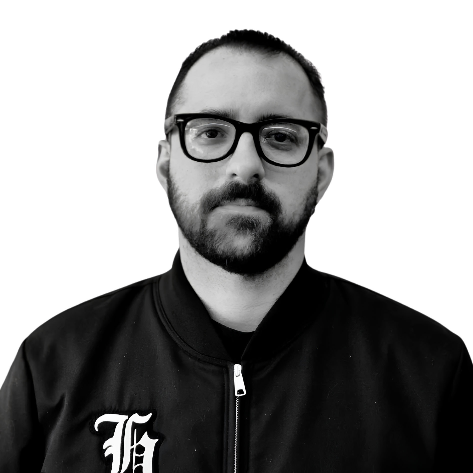 Black and white photo of a man with glasses and facial hair wearing a dark jacket with a zipper.