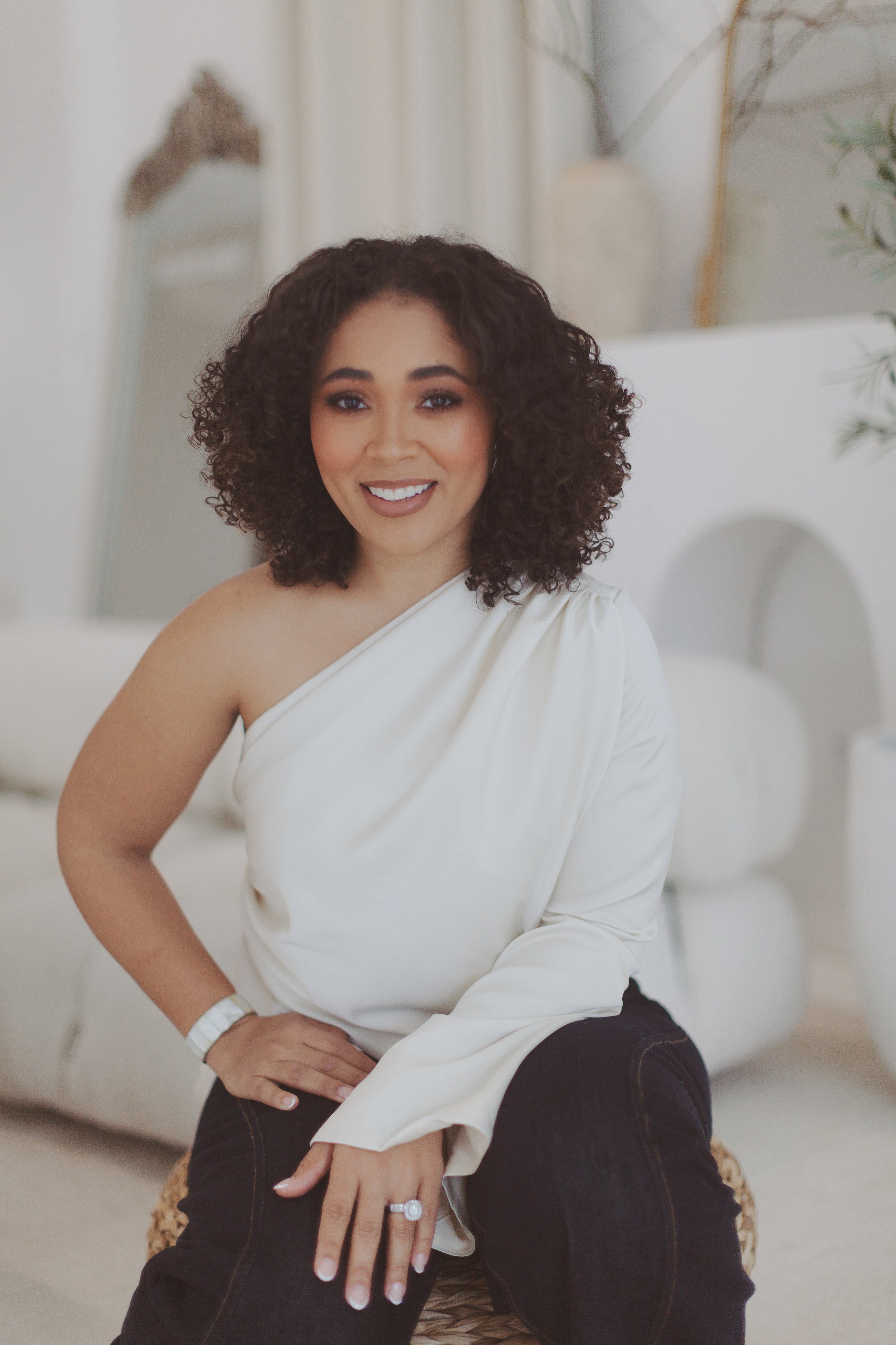 Desaray Wilson sitting and smiling, founder of ReNurture holistic nurse coaching