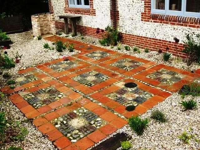 Patio made from reclaimed paments, stable bricks and cobbles