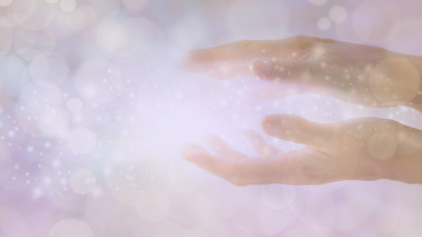Two hands reaching towards a glowing, sparkly light in a soft, pastel-colored background.