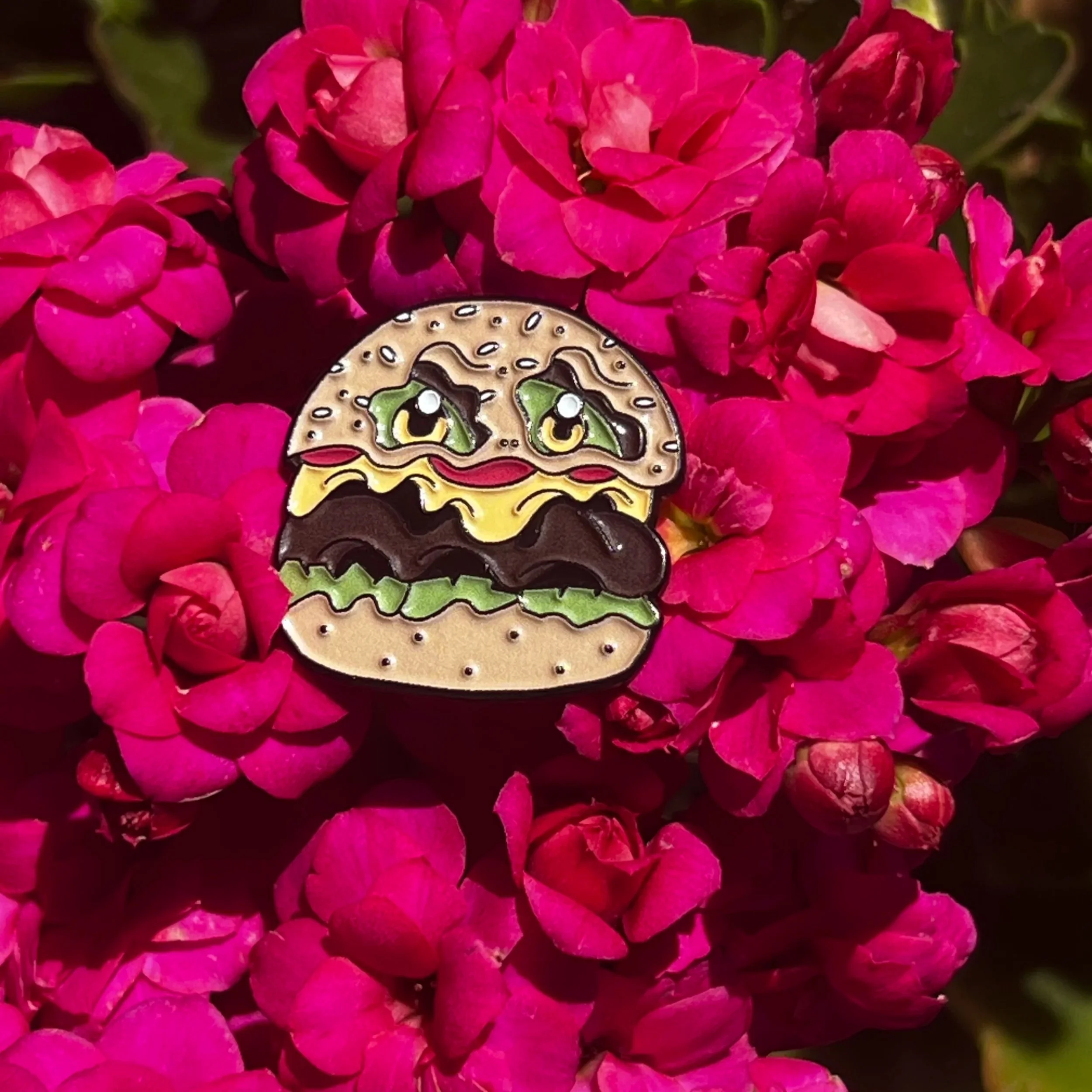 Enor burger monster pin with purple floral background