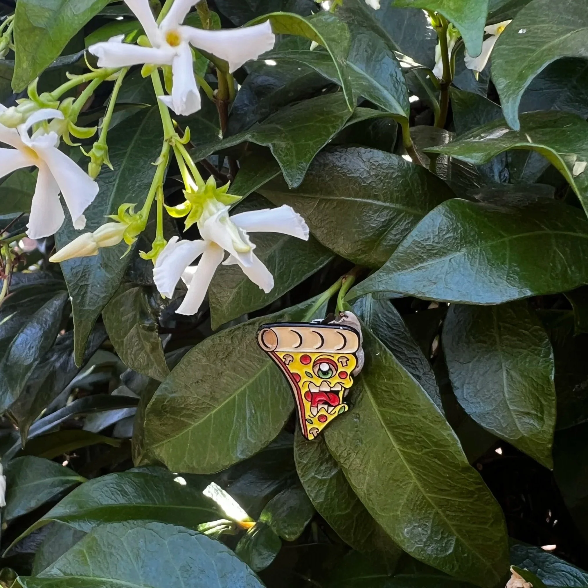 Enor pizza monster enamel pin 1 inch with Jasmine Flower background