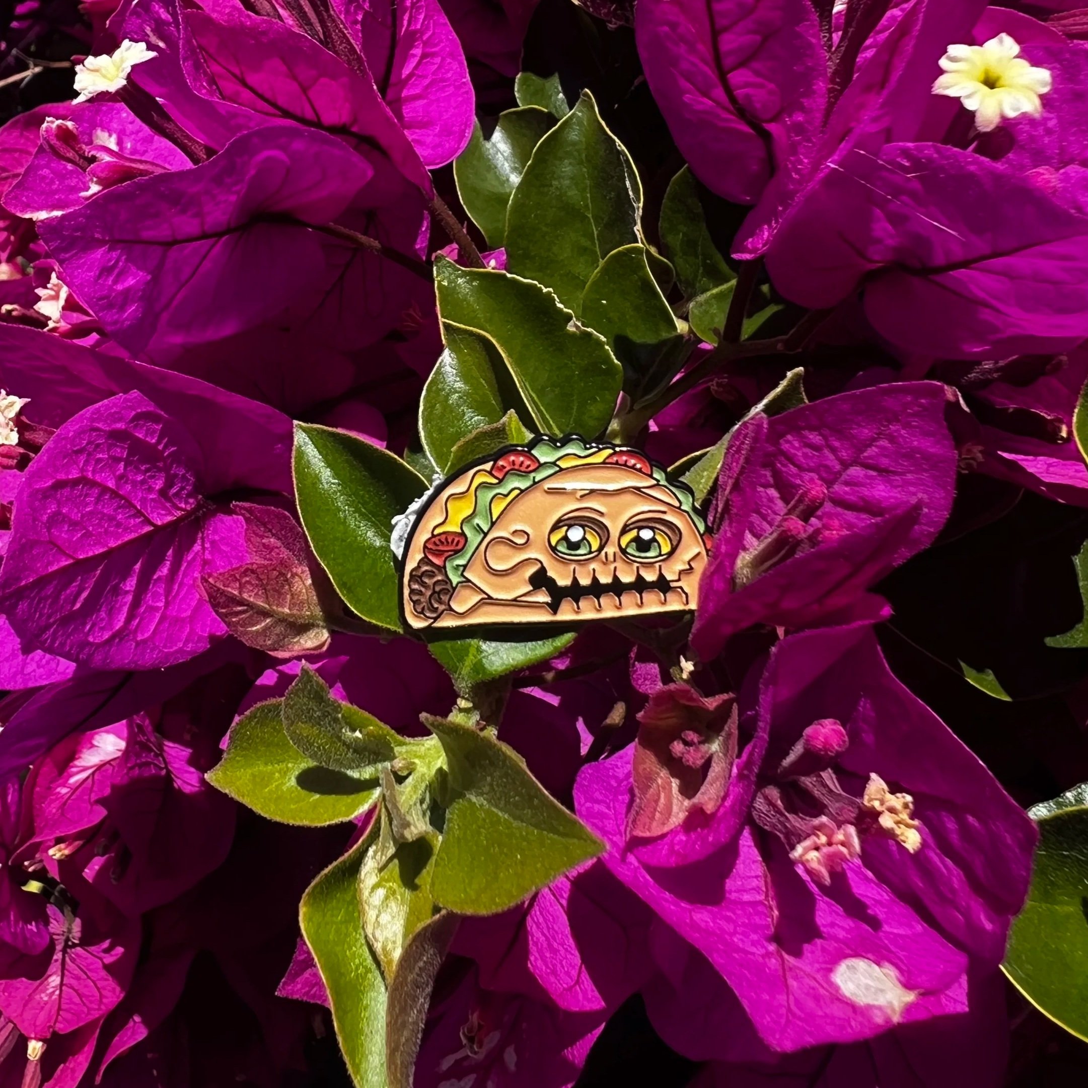 Enor taco monster enamel pin with floral background