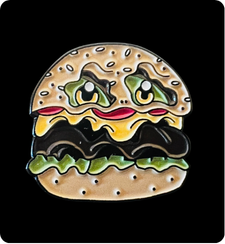 Enor burger enamel pin from his monster munchies collection with a black background