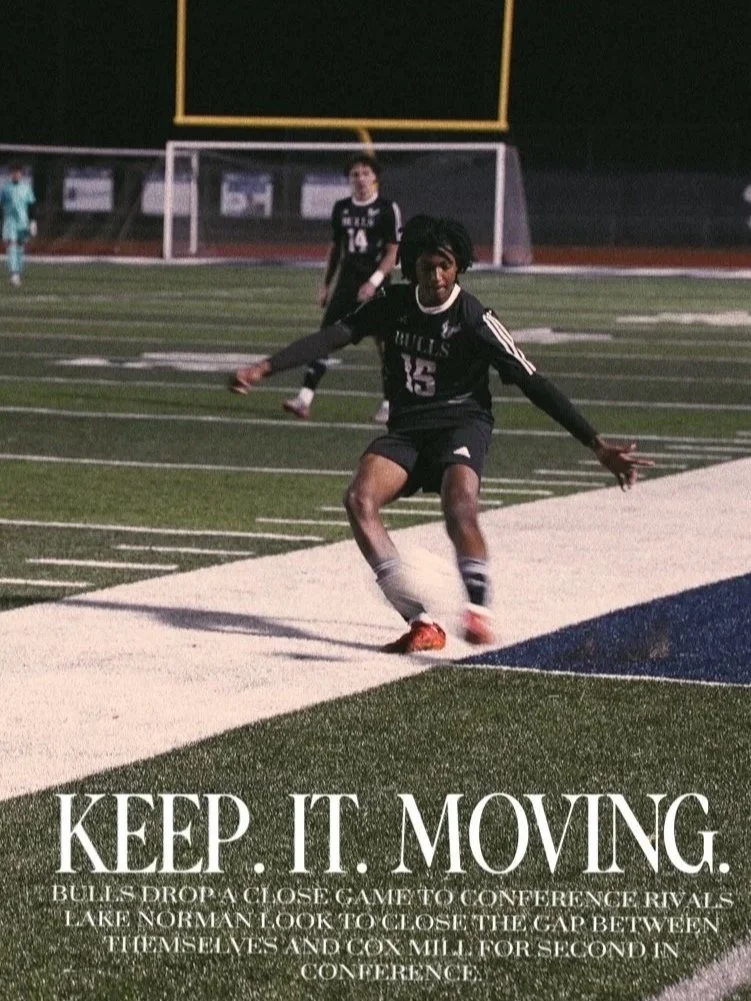 A football player wearing a Black jersey with the number 15 is falling or jumping on a field with turf and sideline markings, with another player in the background and a goalpost.
