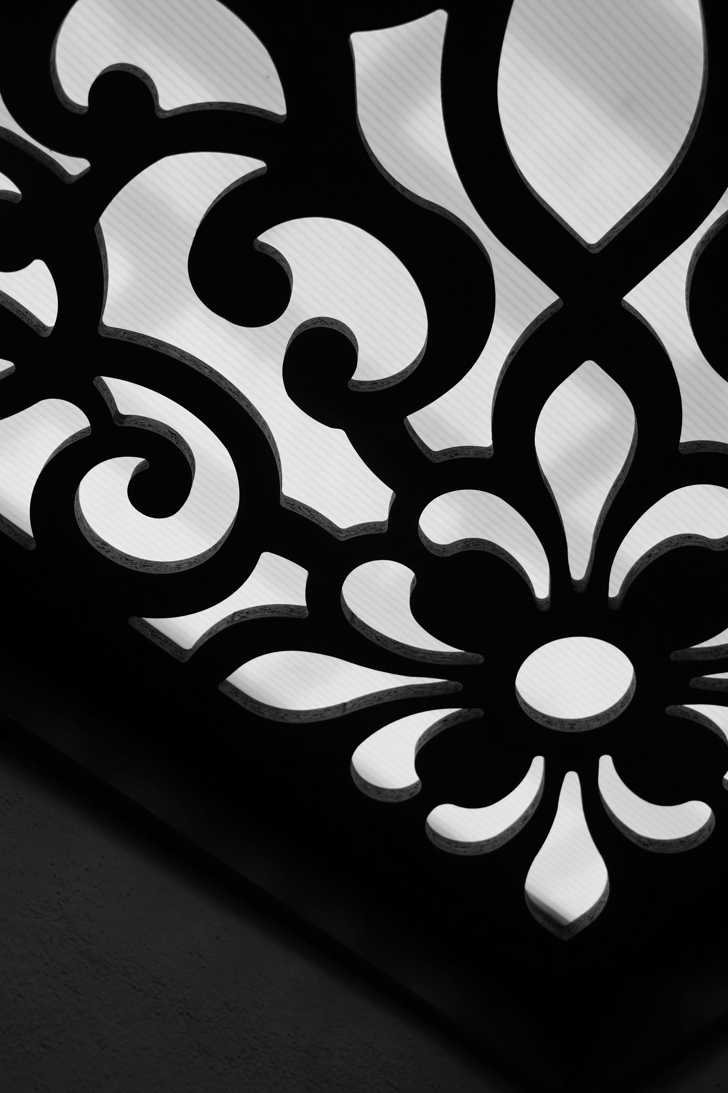Close-up of a decorative metal structure with swirl and heart-shaped cutouts