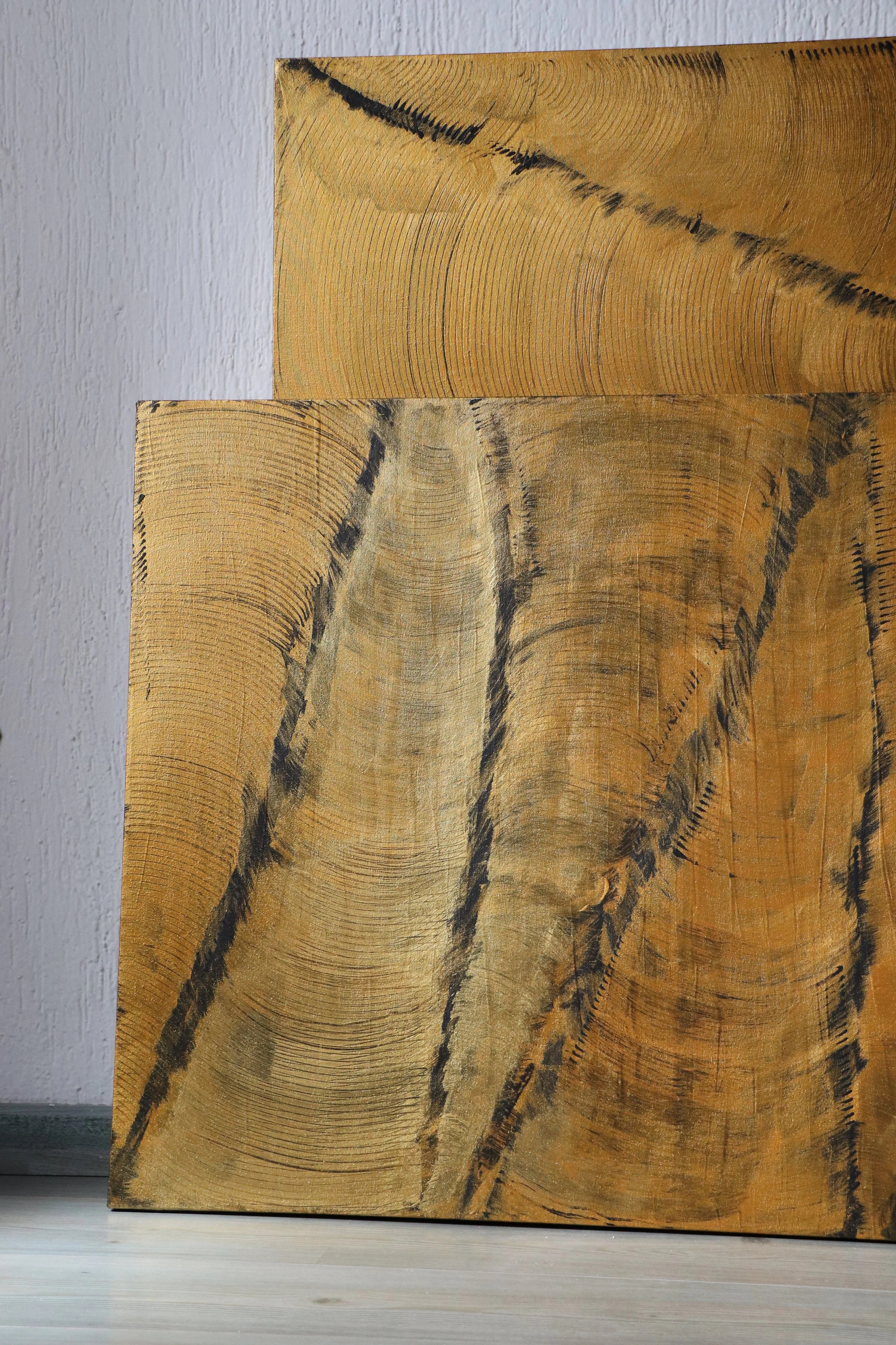 Close-up of a cross-section of a tree trunk showing growth rings and dark lines of the tree's grain.