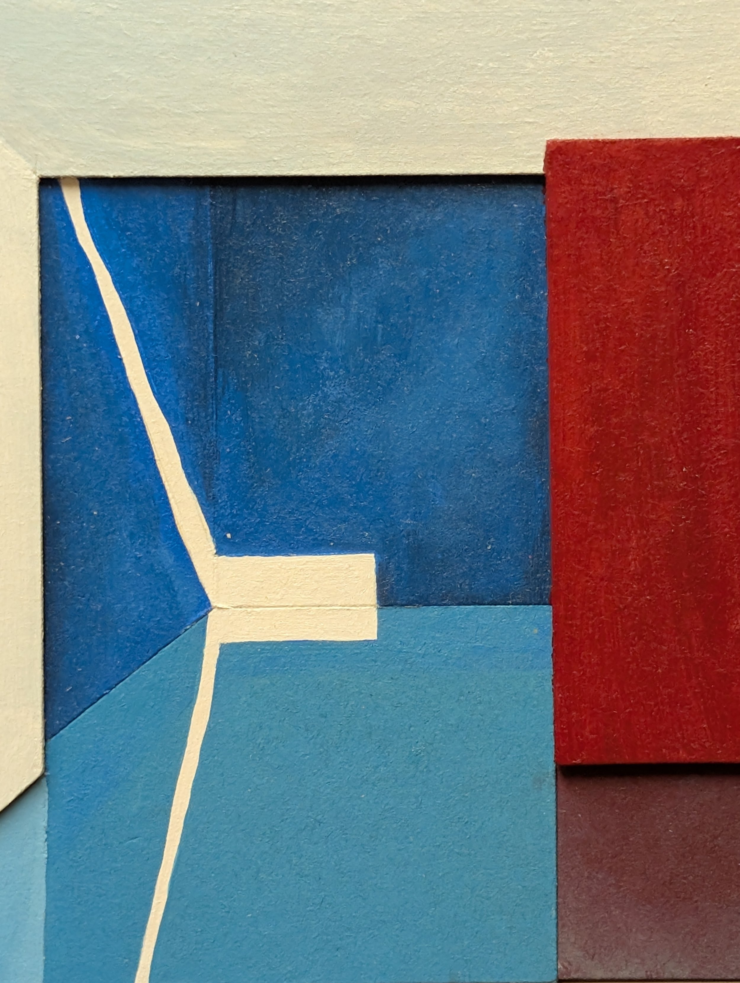 Close-up of a geometric abstract artwork featuring a white line on a blue background, with red and teal sections.