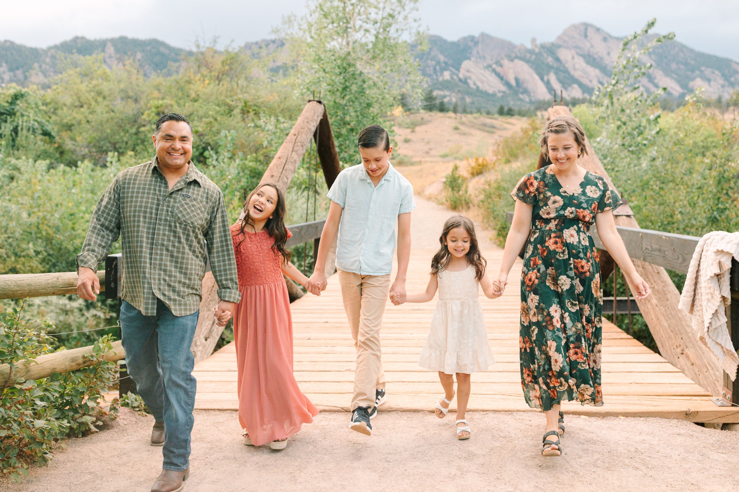 Family of five walking hand in hand at South Mesa Trailhead during a Boulder, Colorado family photography session.