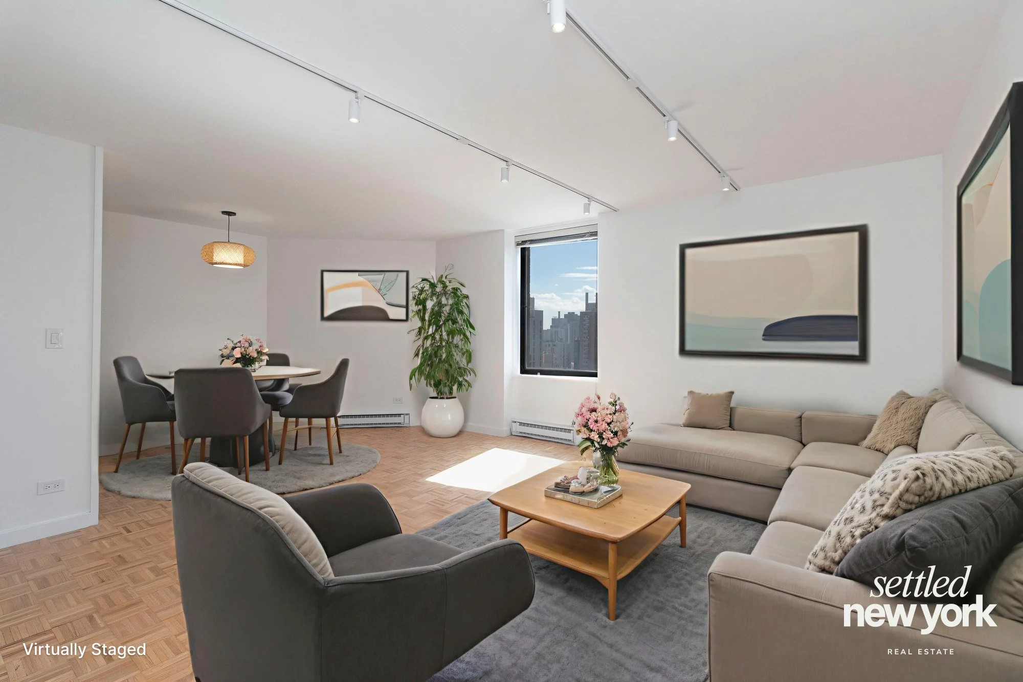 A spacious living room and dining area, with a beautiful sprawling view of Downtown Manhattan visible through the window.
