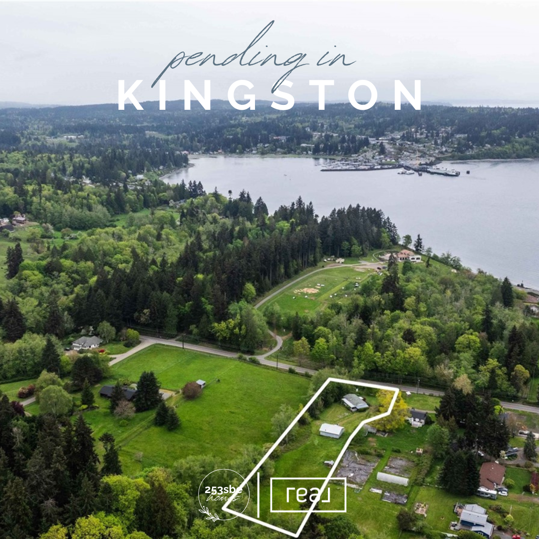 Aerial view of Kingston town near a large body of water, with green forests and residential areas. Overlay text says 'p ending in Kingston' and there is a white outlined area highlighting a property with parts of it marked with data and labels.