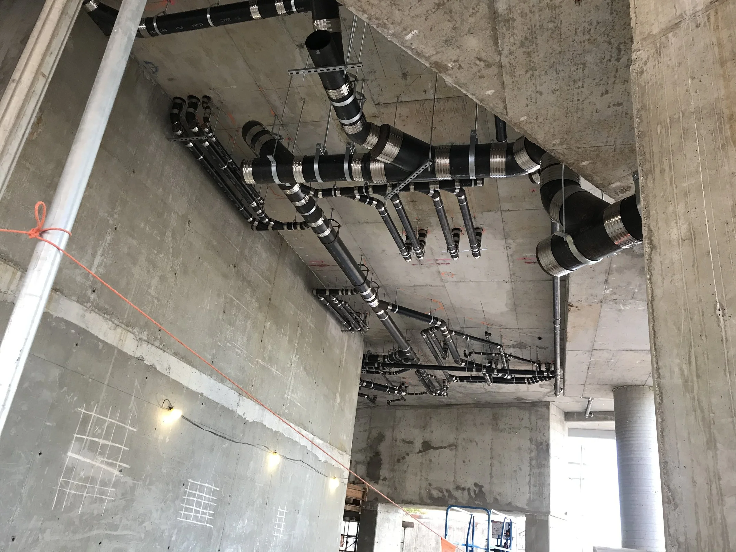 High rise sanitary building connection in Surrey BC for a 42 story building. cast iron pipe with hub less connections