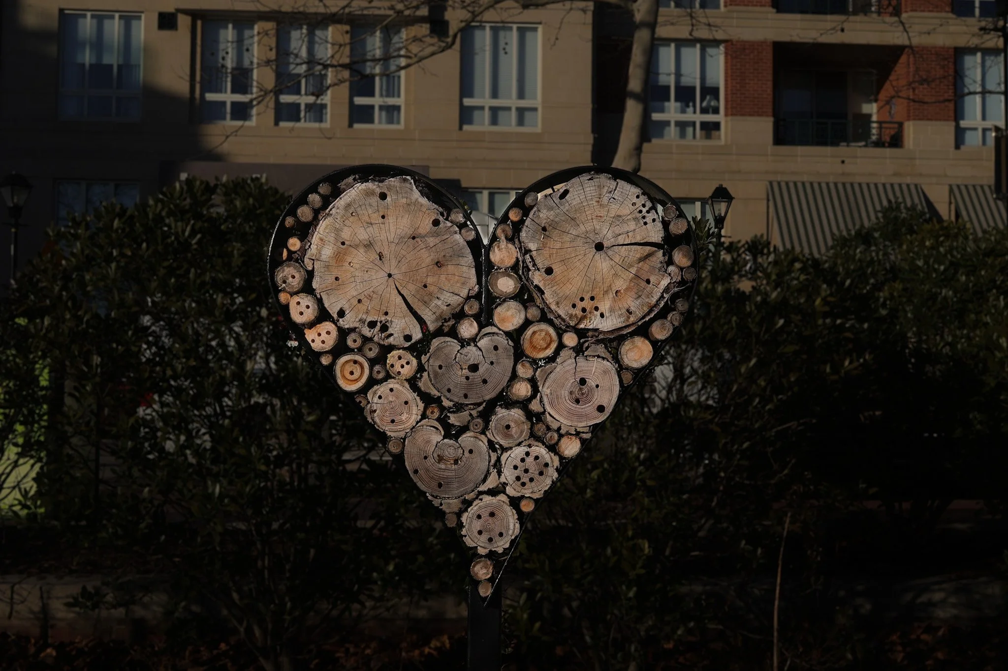 Photo of a heart made out of wood over a street