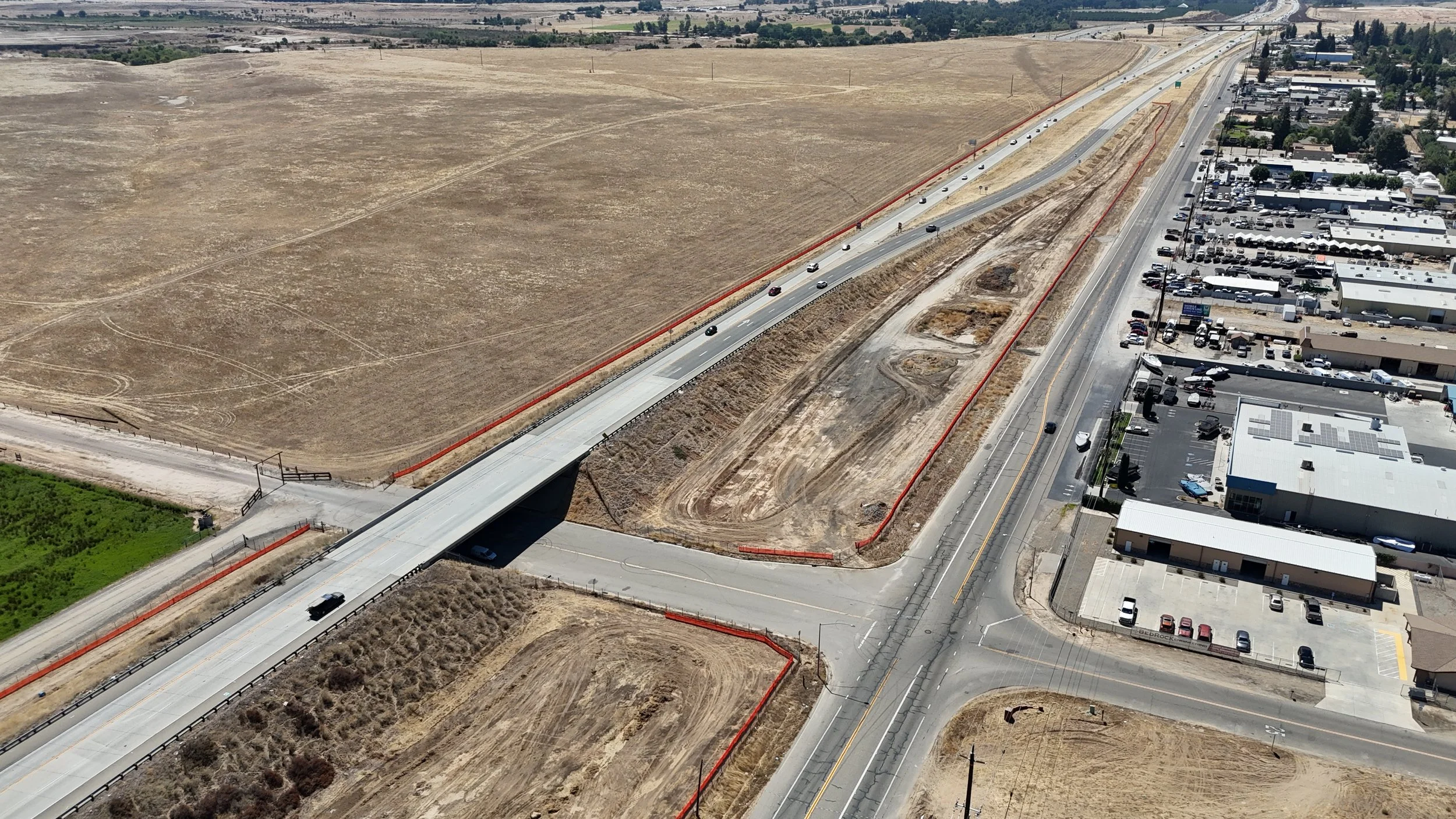 Ave 11 bridge demonstrating the orange fencing on the left and the underpass road fencing.