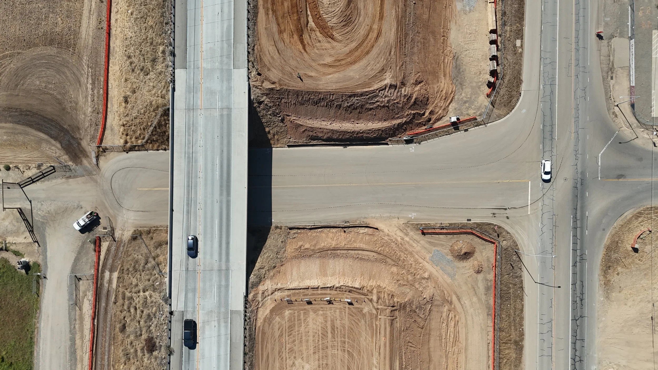 An aerial view of the Avenue 11 bridge with a road that has two intersections underneath.