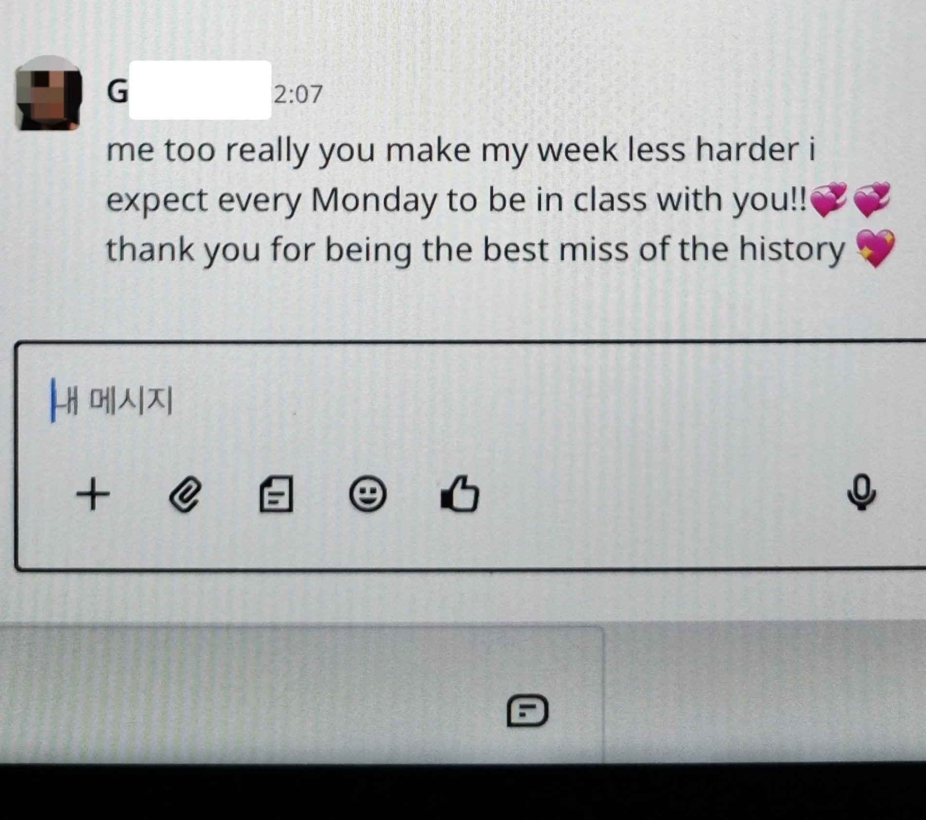 A screenshot of a messaging app showing a message with a redacted sender's profile picture, timestamp, and text expressing appreciation and affection, including three pink heart emojis and one pink and yellow heart emoji.