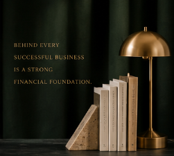 Decorative books arranged on a table with a gold desk lamp and a dark green curtain backdrop, featuring a quote about business and financial foundation.