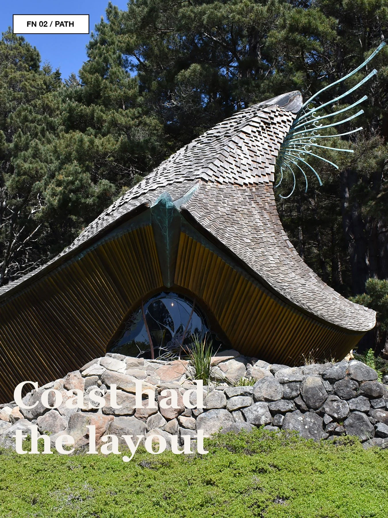 Path curving through lawn and trees toward the Sea Ranch chapel.