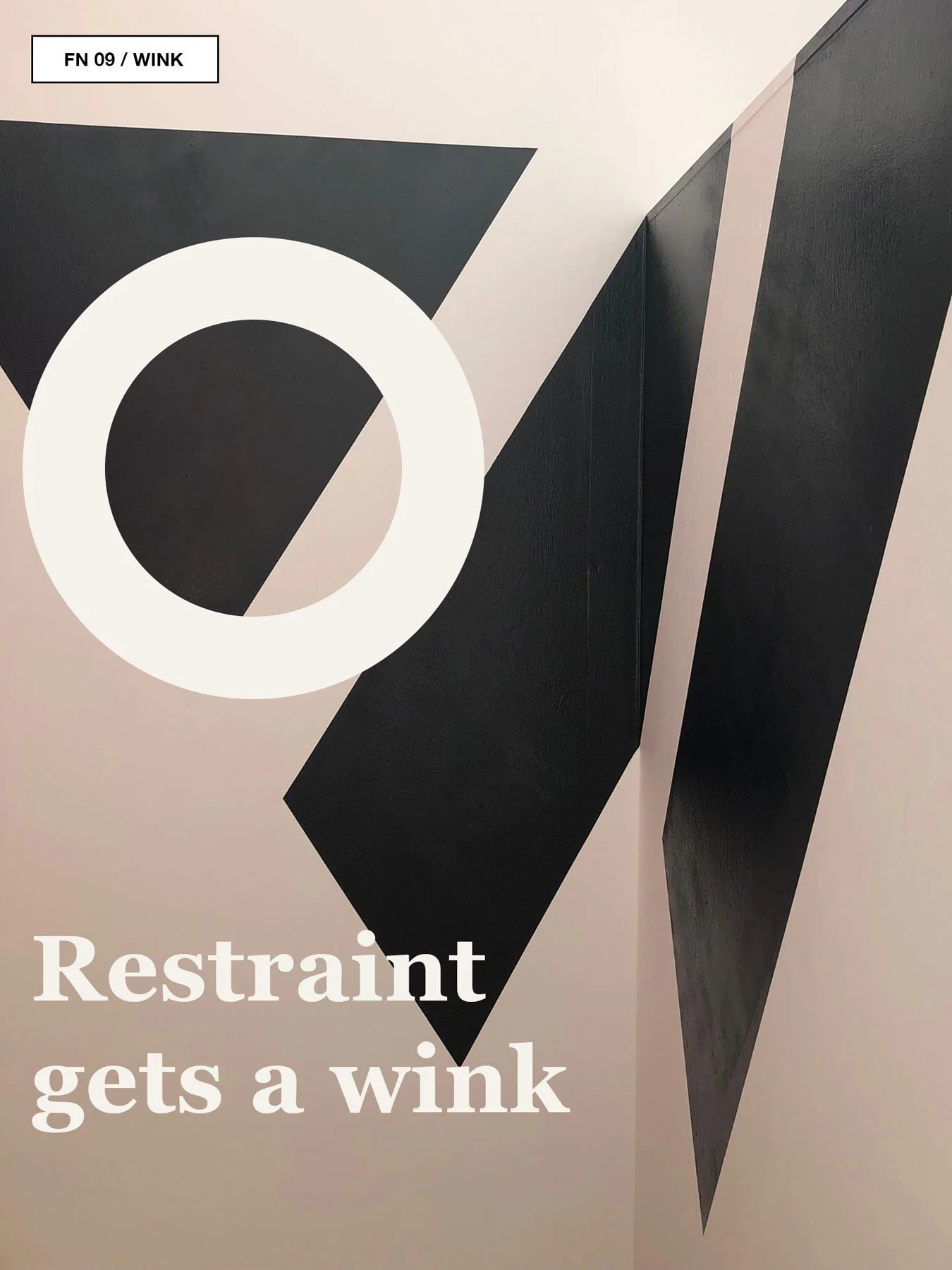 Black triangular supergraphic shapes painted on a pale interior wall.