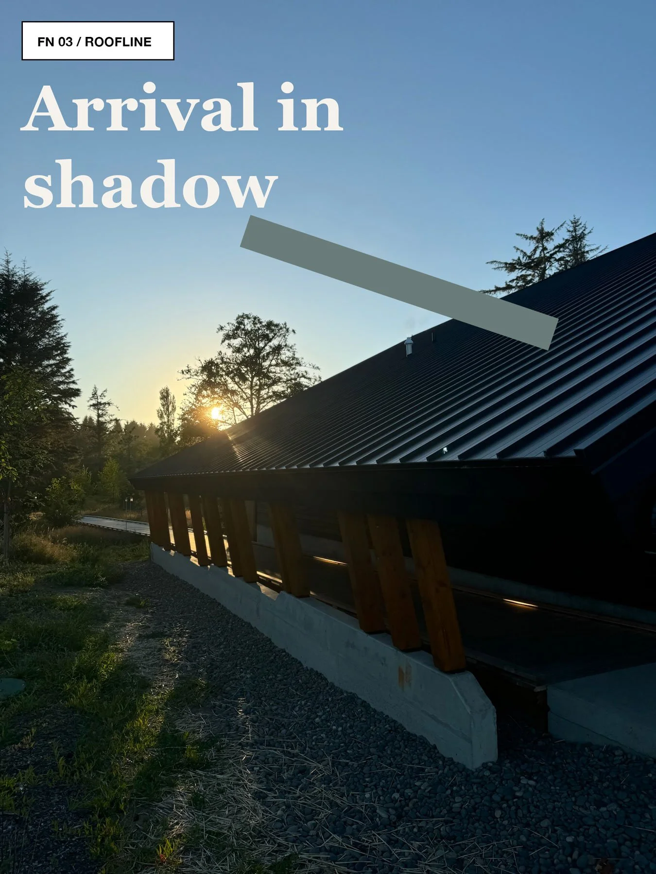 Low timber building at Snow Peak Campfield at dusk, with warm light, a dark roofline, and gravel path.