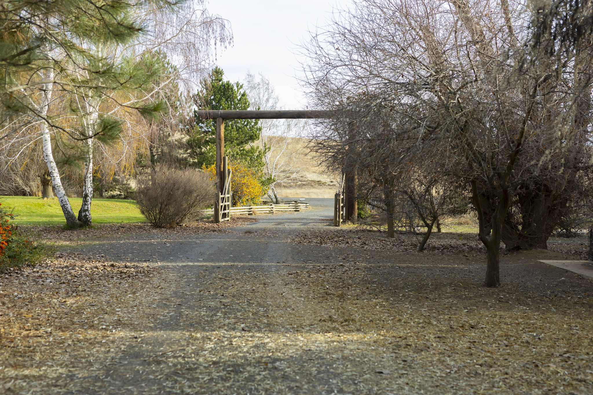 Ranch Entrance with a gravel driveway.