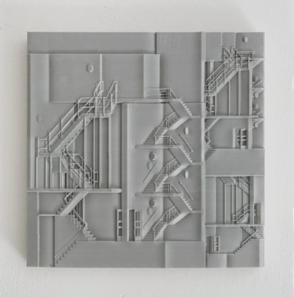 A white textured wall sculpture of multiple staircases and landings arranged in a geometric pattern.