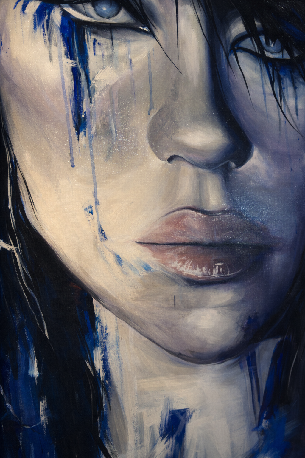 Close-up of a painting of a woman's face with blue and white tones, showing her nose, lips, and partially her eyes and hair, with blue paint drips and splashes.